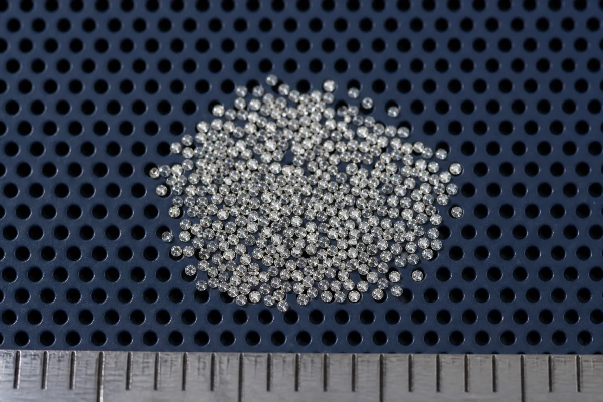 A parcel of minus-two melee diamonds on a calibrated sieve plate